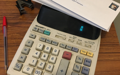 Accountant's calculator, a major tool of a payroll specialist.